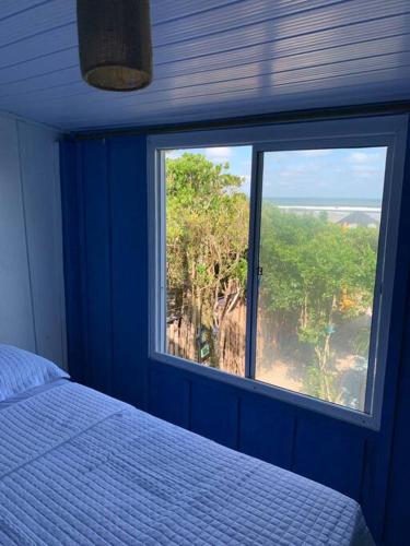 a bedroom with a window with a bed and a view at Bela Vista - Casa Beira Mar in Paranaguá