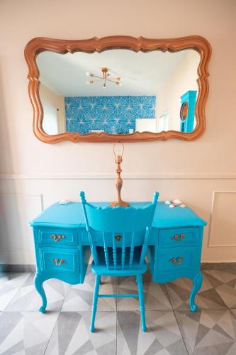 a blue dressing table with a blue chair and a mirror at Casa Navarro in La Paz