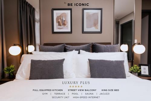 a bedroom with a large white bed with pillows at Condesa Luxury Apartments in Mexico City