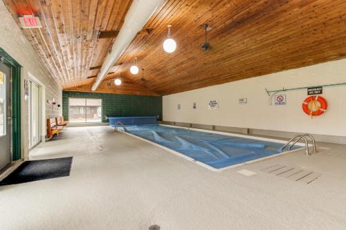 an empty swimming pool in a gym with a wooden ceiling at Bay Point Hillside 17A Down in Whitefish
