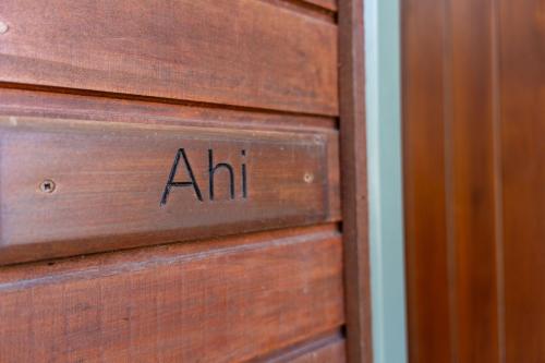 a wooden drawer with the word air written on it at Koru Lodge in Raglan
