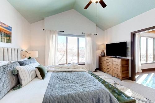 a bedroom with a bed and a flat screen tv at Wild Horse Meadows in Eden