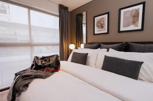 a purse sitting on a bed in a bedroom at Condesa Luxury Apartments in Mexico City