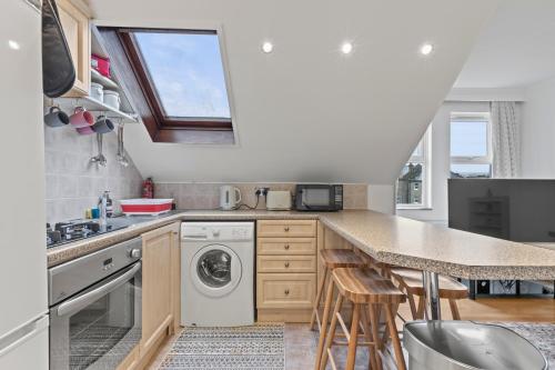 a kitchen with a sink and a dishwasher at Cosy Flat In London in Ealing