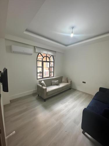 a living room with a couch and a window at Long Street Aparments in MEYDAN in Trabzon