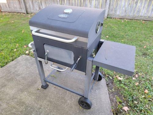 a grill sitting on a stand in a yard at Beautiful Craftsman Style Home w/ Fenced Yard in South Beloit
