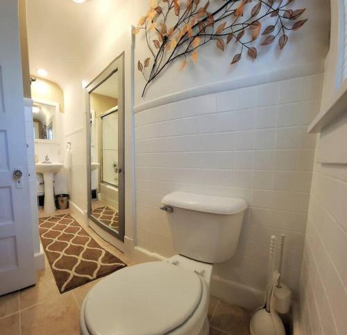 a bathroom with a white toilet and a sink at Beautiful Craftsman Style Home w/ Fenced Yard in South Beloit