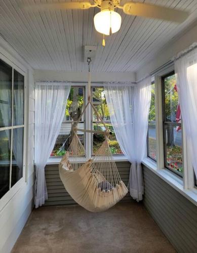a porch with a hammock in a room with windows at Beautiful Craftsman Style Home w/ Fenced Yard in South Beloit