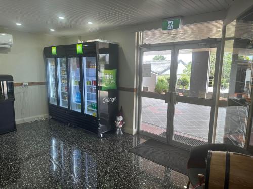 a gas station with a soda machine in a building at ibis Styles Orange in Orange