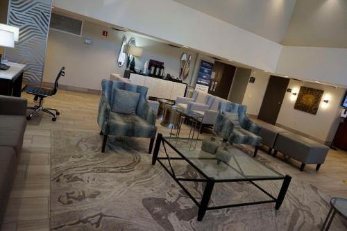 a lobby with a waiting room with chairs and a table at Best Western Tallahassee Downtown Inn and Suites in Tallahassee