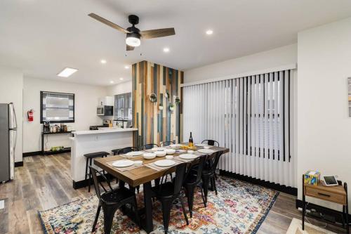 a dining room with a table and a kitchen at Sand & Sun Retreat,2 Living Rooms, Kids Play Area in Michigan City