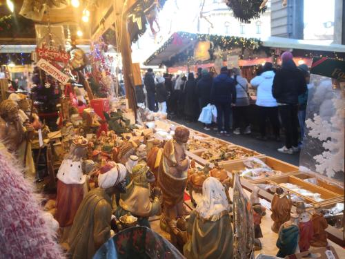 a group of people standing around a market with figurines at Locanda San Paolo in Monza