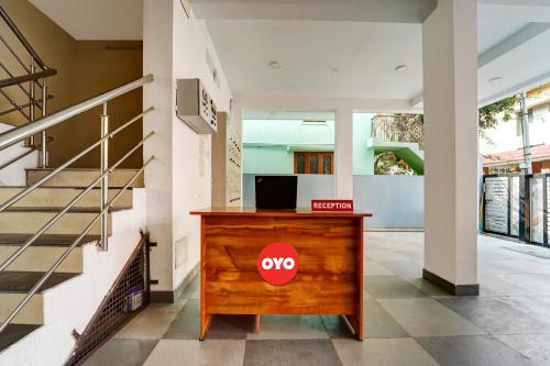 a wooden desk with a yo sign on it in a hallway at Motel Magic in Coimbatore