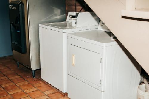 a white washer and dryer sitting in a kitchen at Victorian Inn & Suites in Nacogdoches