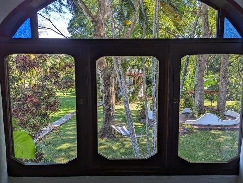 a view from a window of a yard at spirit of jungle lodge in Sámara