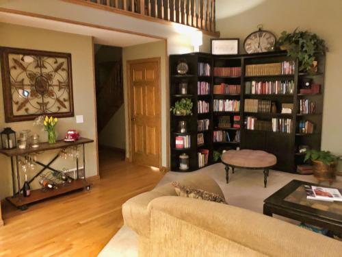 a living room with a couch and book shelves at North Oaks Estate in Blaine