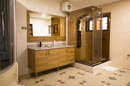 a bathroom with a sink and a shower at ED&DRE Luxuria Hotel in Ibadan