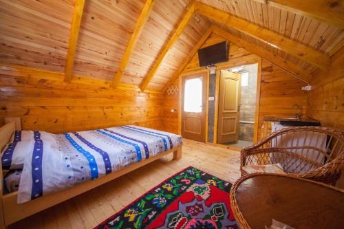 a bedroom with a bed in a log cabin at Gazela Bungalov 1 in Mojkovac