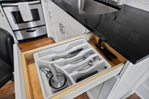 a kitchen drawer with a sink and utensils in it at The Maverick, powered by Placemakr - River Walk in San Antonio