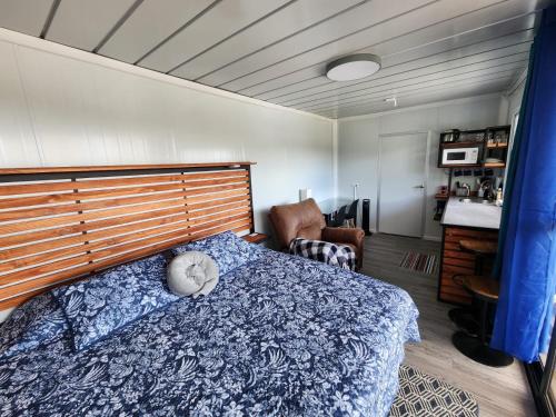 a bedroom with a bed with a wooden head board at Monteverde Numu in Monteverde Costa Rica