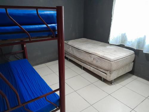 a bedroom with a bunk bed next to a window at Cantinho do sossego in Macaé