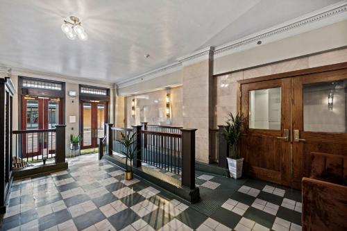 a lobby of a building with a staircase and a door at The Maverick, powered by Placemakr - River Walk in San Antonio