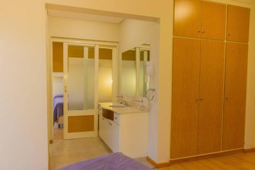 a small bathroom with a sink and a counter at Soleado Apart Hotel in San Rafael