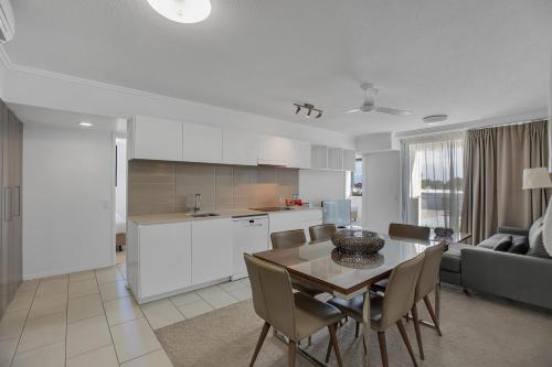 a kitchen and dining room with a table and chairs at Stunning 2 Bedroom Self Contained City Apartment in Mackay