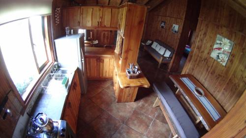 an overhead view of a kitchen with a refrigerator at Los arrayanes de huife pucon in Termas De Huife