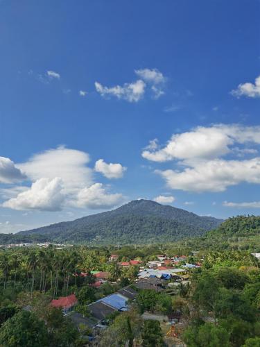 a view of a town with a mountain in the background at Homestay Pangsapuri Simfoni 3BR 7Pax Kuah Langkawi in Kuah