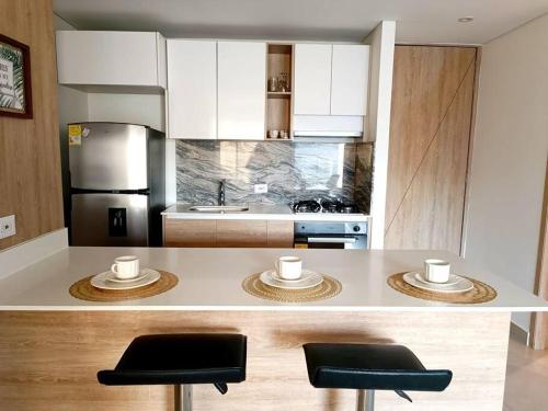 伊瓦格的住宿－Moderno y céntrico apartamento.，厨房配有带2张凳子的台面