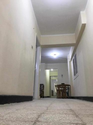 an empty room with chairs and a white wall at Buba apartment 