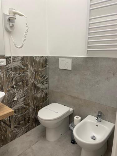 a bathroom with a toilet and a sink at Cavour16 rent bedrooms in Genova