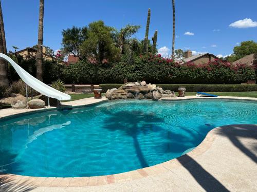 a swimming pool with a slide in a yard at Paradise in Scottsdale with Pool Oasis & Game Room in Phoenix