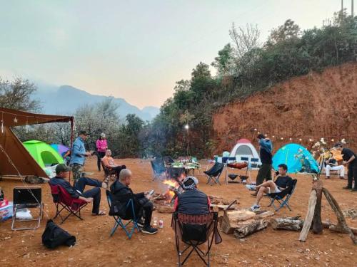 a group of people sitting around a camp fire at Ngoc Chien Pearl in Ngọc Chiến