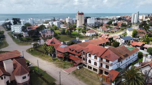 an aerial view of a city with houses and the ocean at Hotel Portofino by CPH in Villa Gesell