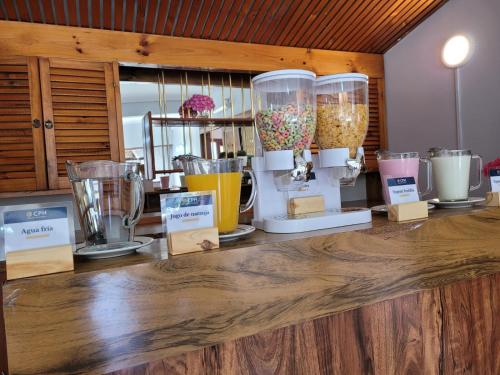 a counter with many different types of glass blenders at Hotel Portofino by CPH in Villa Gesell