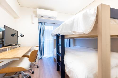 a dorm room with bunk beds and a desk at Brilliant MK- III in Tokyo