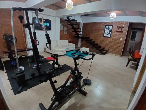 a living room with a gym with a treadmill at Entre Aves hospedaje in Luna Park