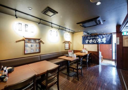 a dining room with wooden tables and chairs at TKP Sunlife Hotel in Fukuoka