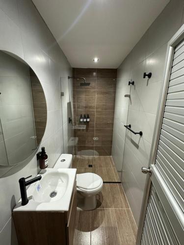 a bathroom with a toilet and a sink and a shower at Casa Gali in Ríohacha