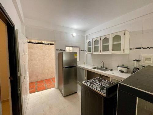 a kitchen with a stainless steel refrigerator and a sink at Apartamento en zona de Torices in Cartagena de Indias
