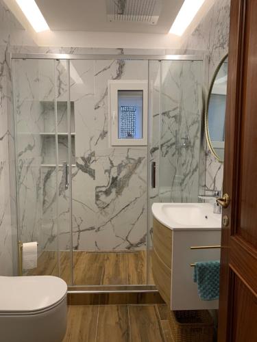 a bathroom with a shower and a toilet and a sink at CASA BASTIO in La Spezia