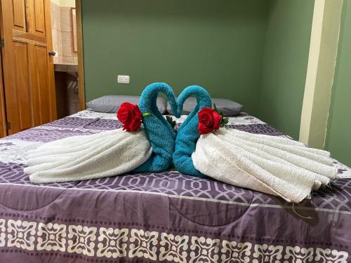 a bed with two towels on top of it at Ceiba lodge in Drake