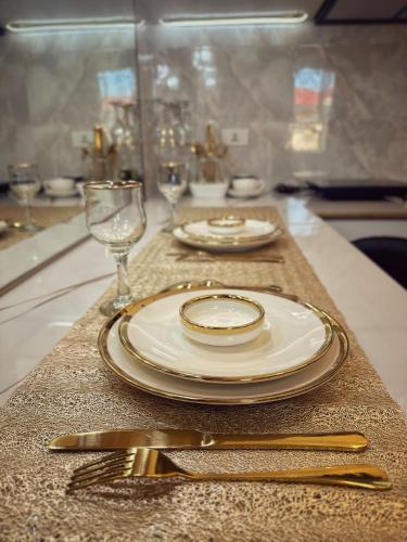 a table with plates and silverware on a table at RFR Condo Suites in Bacolod