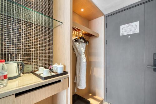 a room with a closet with a robe hanging in it at 义乌国际大厦酒店 in Yiwu