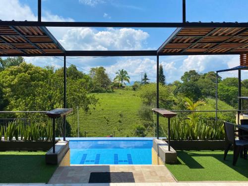 a view of a swimming pool from a house at Hotel Casa campestre HH in Quimbaya