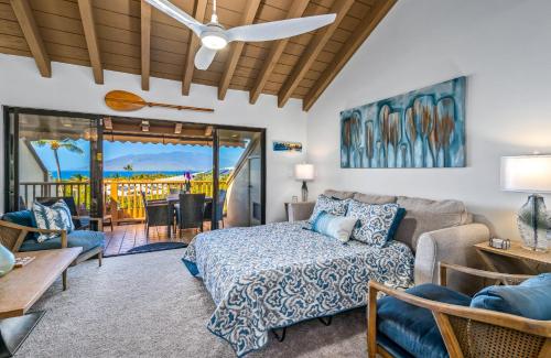 a living room with a bed and a couch at Luxurious & Spacious Ocean Vistas in Wailea
