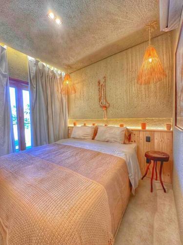 a bedroom with a large bed and a window at Villa Aconchego - Casas de Luxo in São Miguel dos Milagres