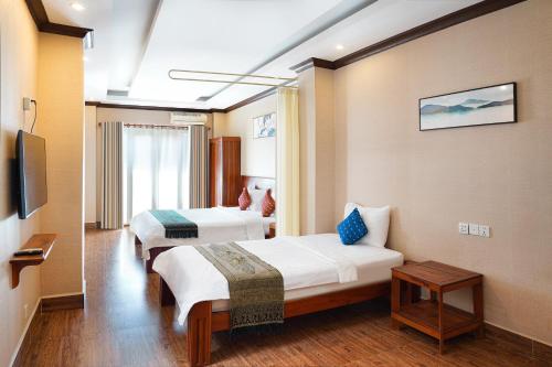 Postel nebo postele na pokoji v ubytování Phuminh Hotel Riverside